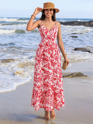 Floral faux-wrap midi dress with red print, spaghetti straps, defined waist, and tiered hem.
