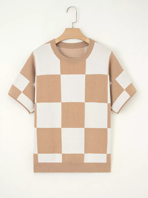 Drop shoulder sweater in camel and white checkerboard pattern with crew neck and short sleeves.