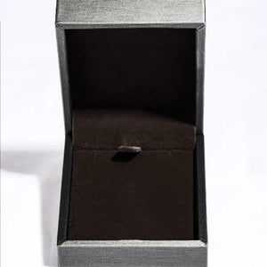 Open jewelry box with dark brown velvet lining and textured gray exterior.