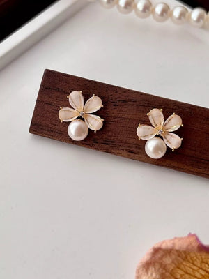 light pink earrings featuring pearl accent and floral