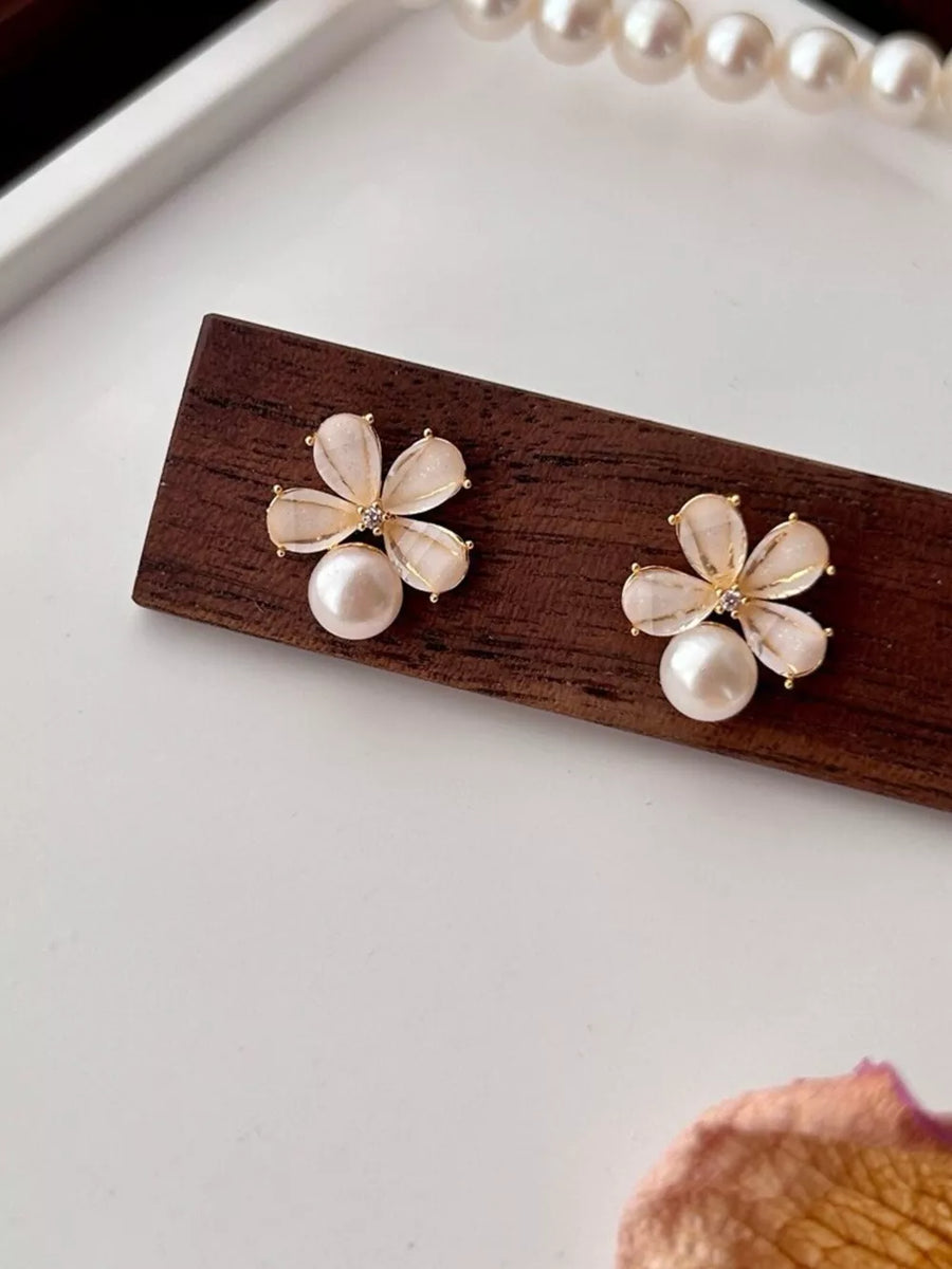light pink earrings featuring pearl accent and floral