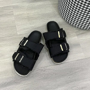 Black denim frayed-edge buckle slides with silver hardware.