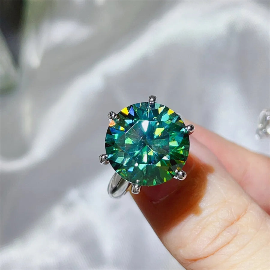 Green moissanite solitaire ring in 925 sterling silver with six prongs.