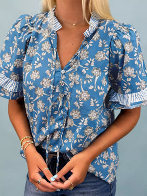 Blue floral cotton blouse with ruffle sleeves and tie neck