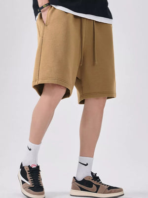 Camel chino shorts with drawstring and relaxed fit, showing side pockets.