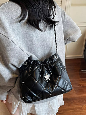 Black quilted shoulder bag with diamond pattern, star rhinestone detail, and chain strap.