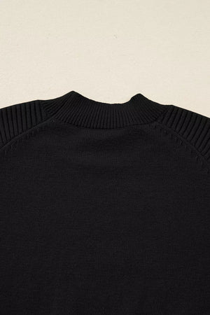 Black acrylic knit sweater with mock neck and ribbed balloon sleeves.