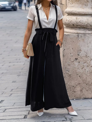 Black culottes with suspender detail and tie waist, wide leg, casual chic style.