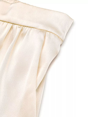 Champagne satin twist-front top and flowing pants set with ruched waistband detail.