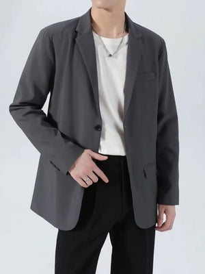 Men's dark gray classic fit blazer with one button closure and notched lapels.