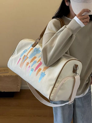 Off White canvas duffle bag with colorful star design and adjustable strap