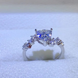 Silver ring with a heart-cut diamond cluster and accent stones.