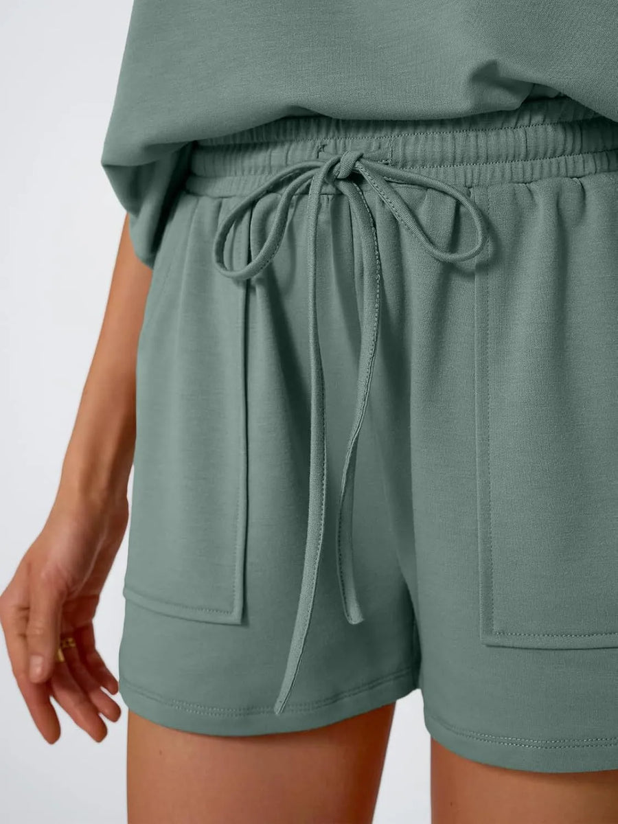 Relaxed fit drawstring shorts set in solid color with functional pockets and tie waist.