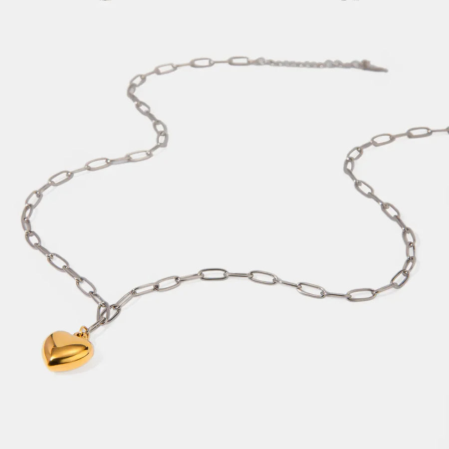 Two-tone heart pendant necklace with silver chain and gold heart charm.