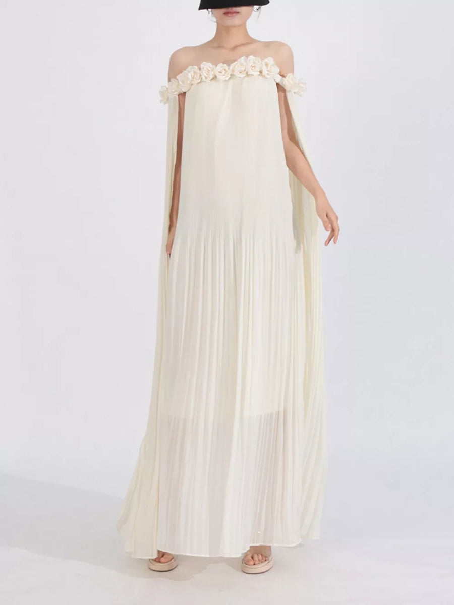 Cream off-shoulder maxi dress with floral applique neckline and cape sleeves.