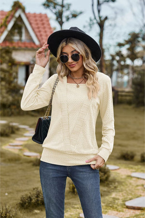Textured knit sweater in ivory with square neckline and long sleeves.