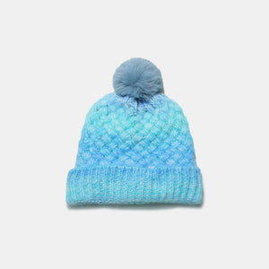 Pastel blue ombre knit beanie with pom and textured weave.