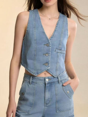 Light blue denim vest with button front and V-neck, cropped length, paired with matching jeans.