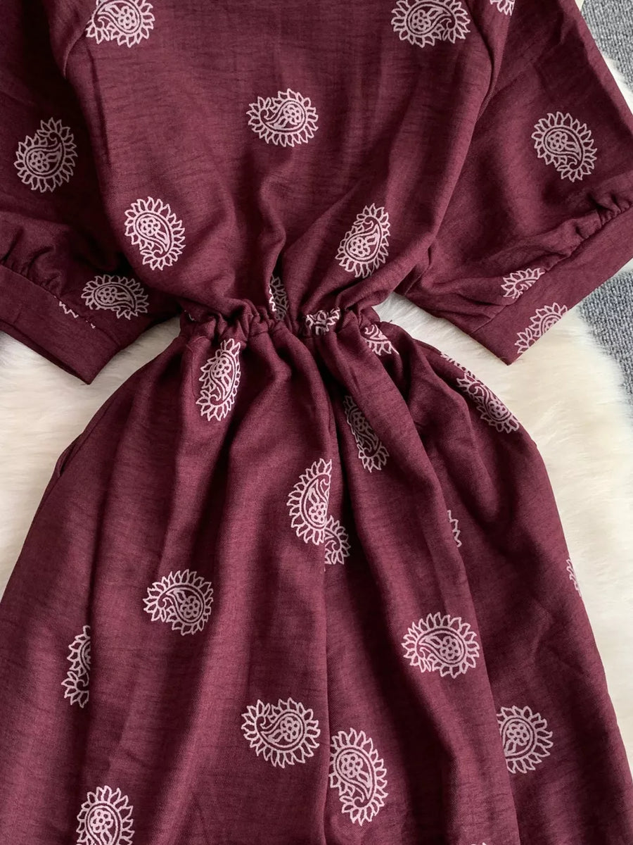Burgundy paisley print drawstring jumpsuit with short sleeves and cinched waist