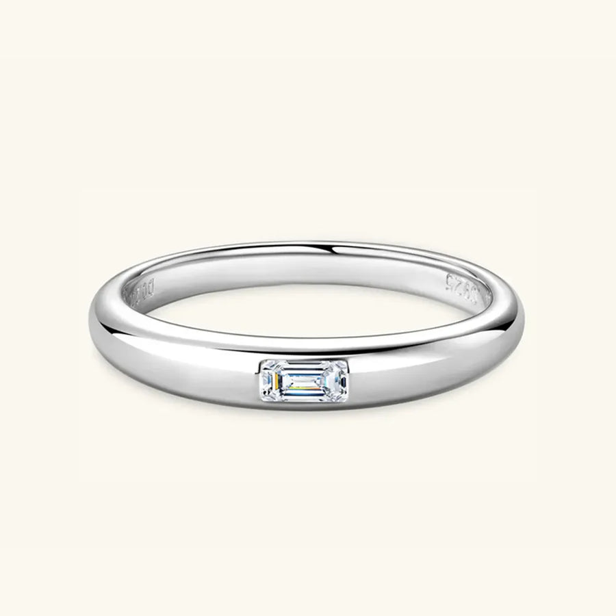 Silver band ring with a single rectangular moissanite gemstone.