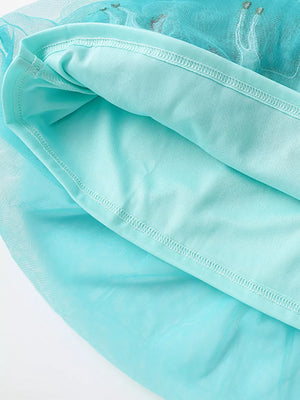 Aqua tulle baby dress with unicorn embroidery detail and cotton lining.