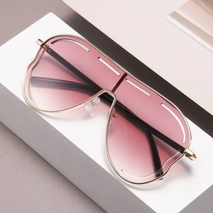 Statement aviator gradient sunglasses with gold metal frames and pink lenses.