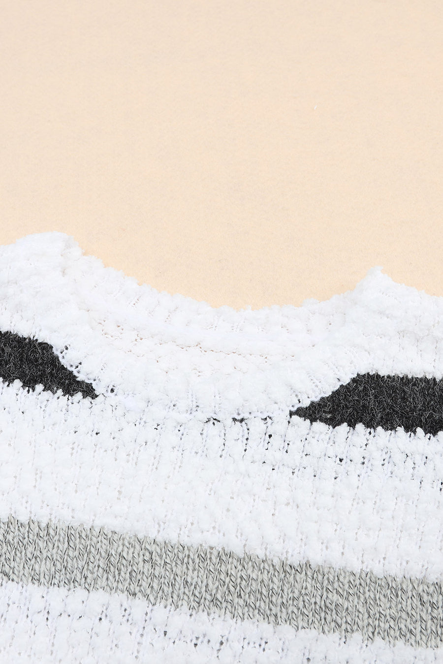 White acrylic sweater with textured stripes and a slouchy knit detail.