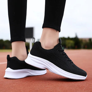 Black textured knit performance runners with white soles and laces.