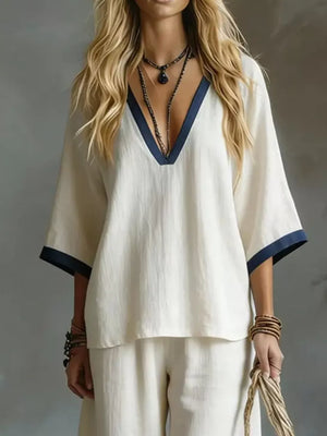 White V-neck two-piece set with contrast trim and wide sleeves.