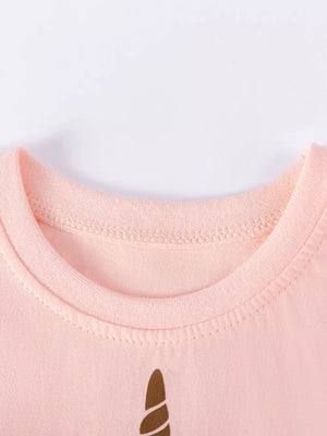 Pink cotton baby dress with unicorn horn graphic and ruffled sleeves detail.