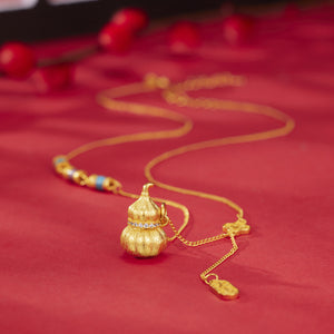 necklace in gold with geometric and gourd pendant