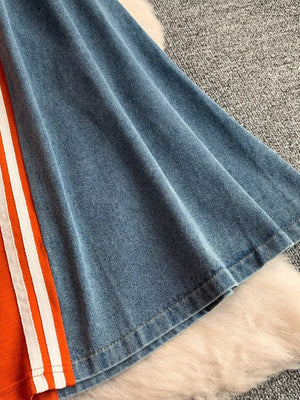 Chic color block casual dress with orange and white stripes on denim fabric.