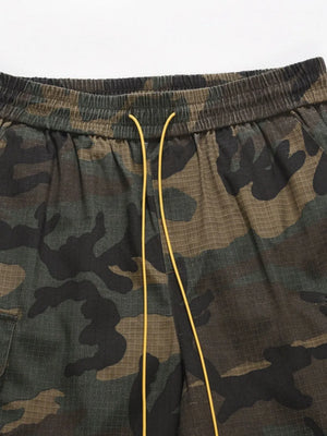 Utility camo cargo shorts with elastic waistband and yellow drawstring.