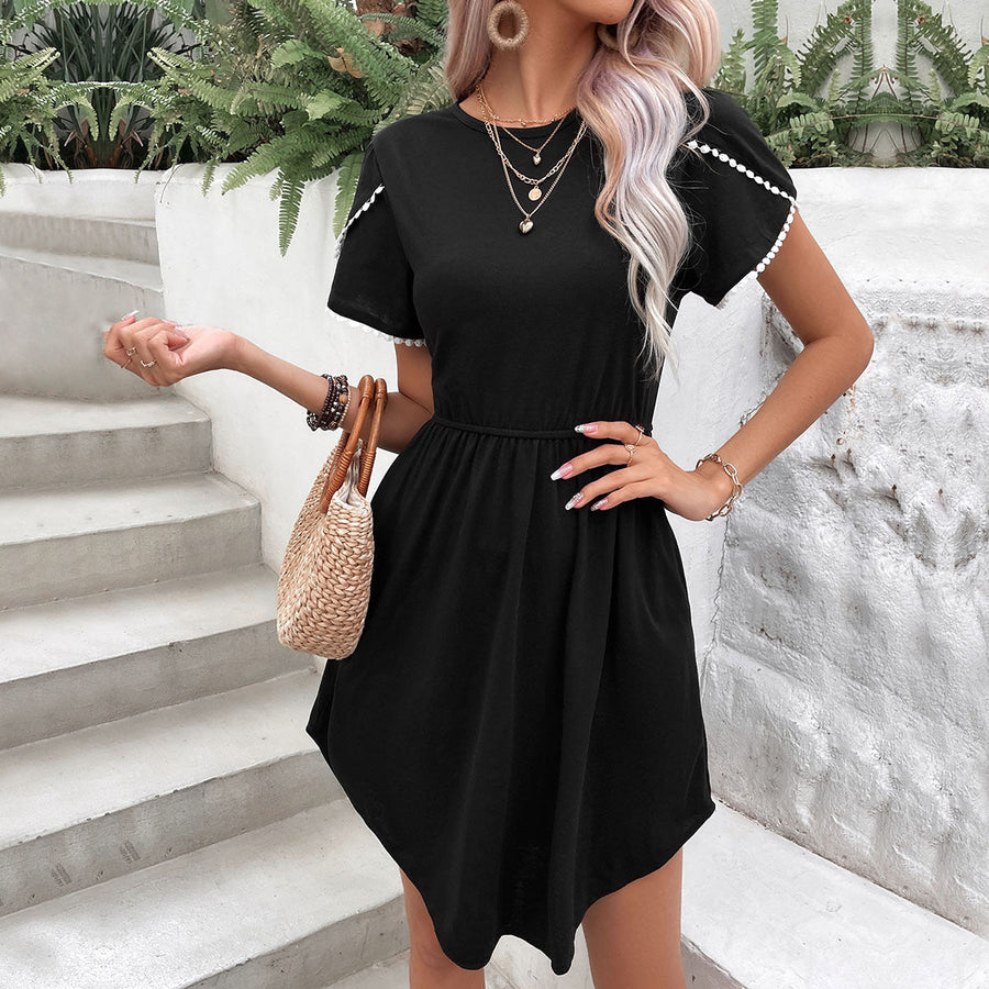 Black day dress with scalloped sleeves and a cinched waist.