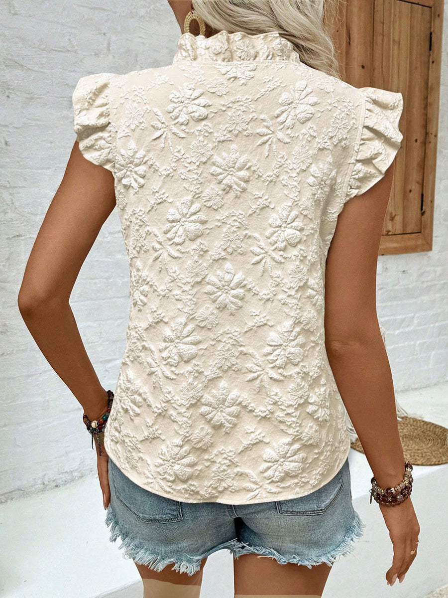 Beige floral embossed ruffle blouse with short sleeves and mock neck.