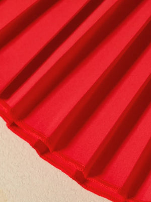 Red pleated baby skirt with decorative hem detail