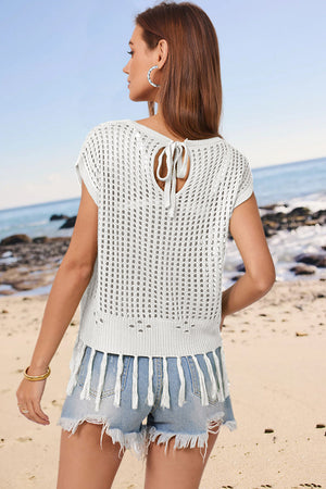White open-knit cover-up with short sleeves, tie-back detail, and tassel hem.