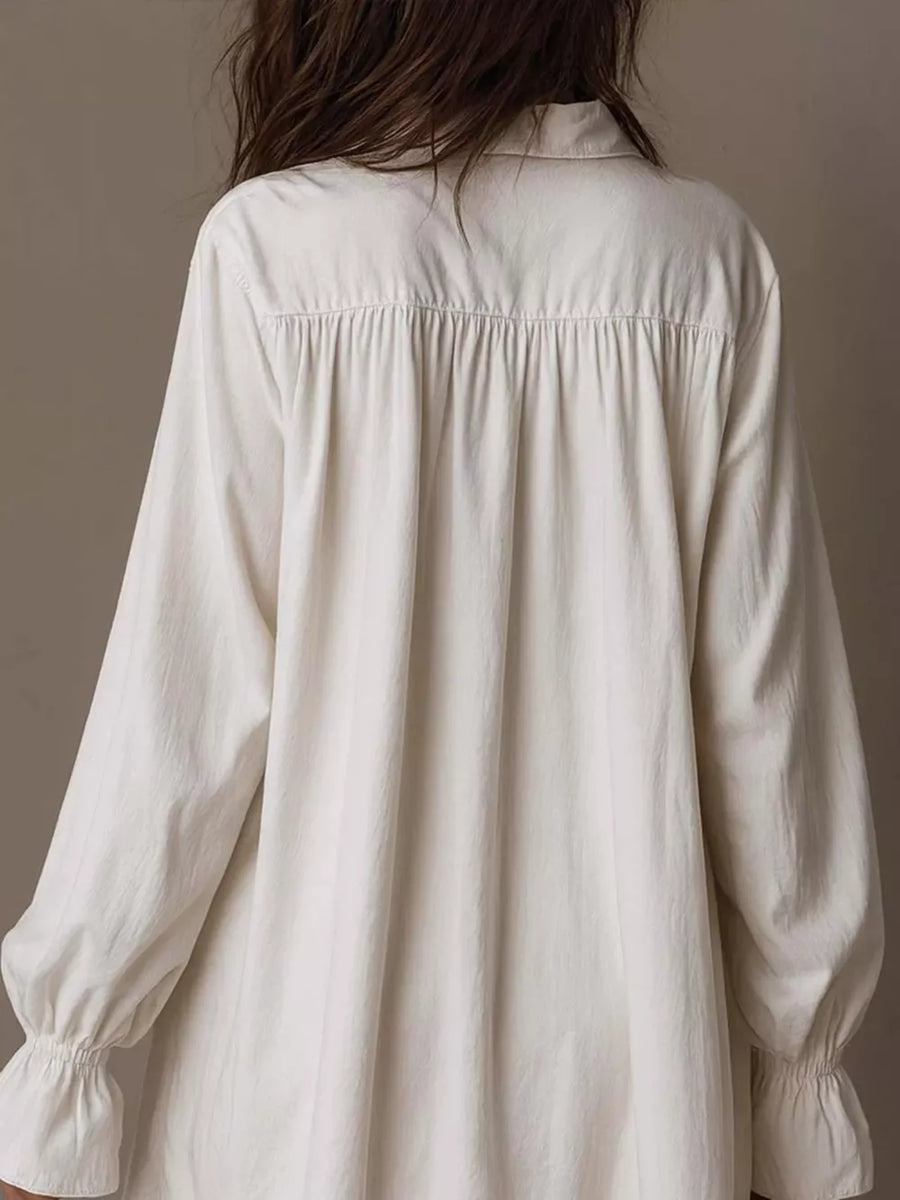 White shirt dress featuring buttoned and embroidered