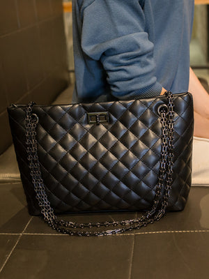 black crossbody bag with turn-lock and quilted