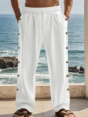 White linen palazzo trousers with side buttons and drawstring waist