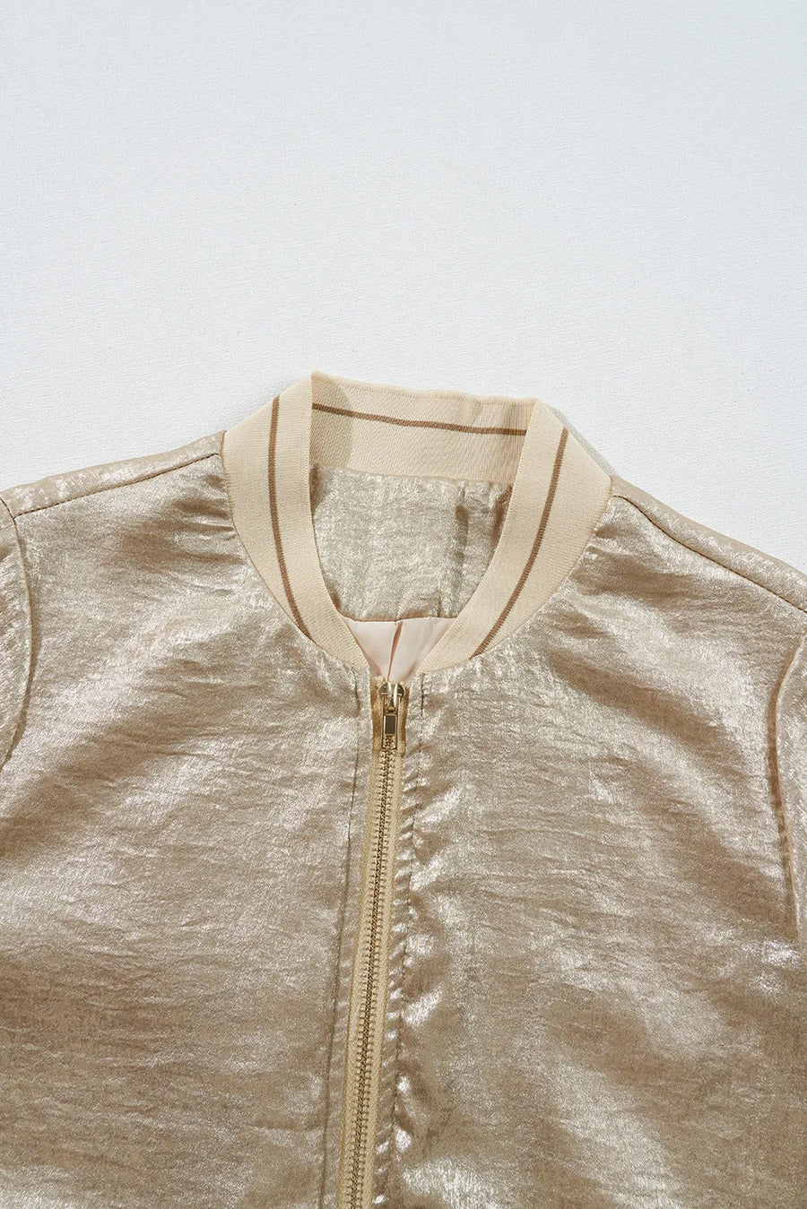 Metallic bomber jacket in tan with ribbed collar and zip closure