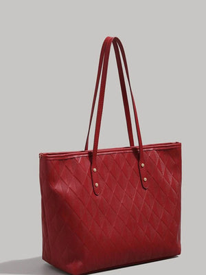 Red quilted pu leather tote bag with diamond pattern and double straps.