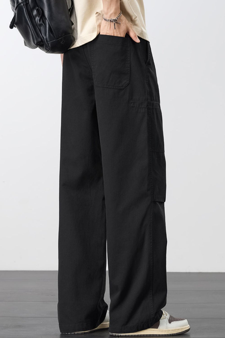 Black cargo pants with adjustable drawstring and multiple pockets