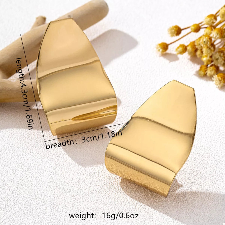 Golden alloy geometric earrings with a wavy, sculpted design.