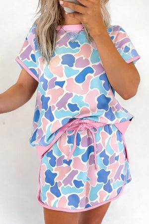 Pastel camouflage athletic two-piece set with crew neck top and drawstring shorts.