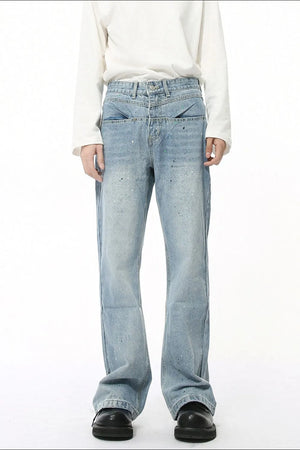 Light wash flare jeans with splatter detail and double waistband