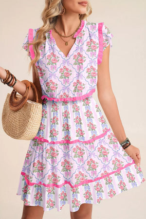 Floral tiered ruffle dress with V-neck, short sleeves, and elastic waist in a bouquet print.