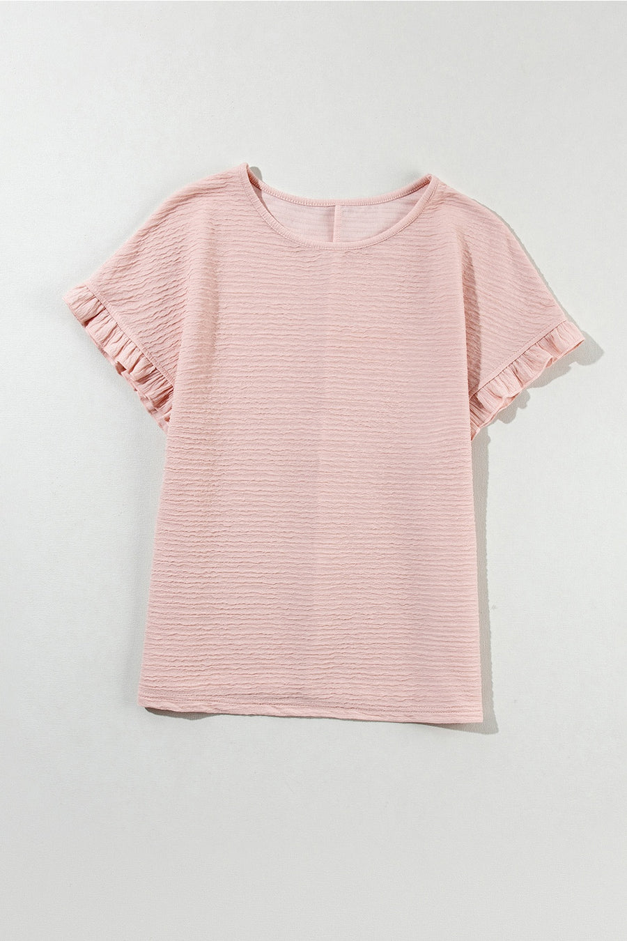 Blush pink textured top with short ruffle sleeves and a crew neck.
