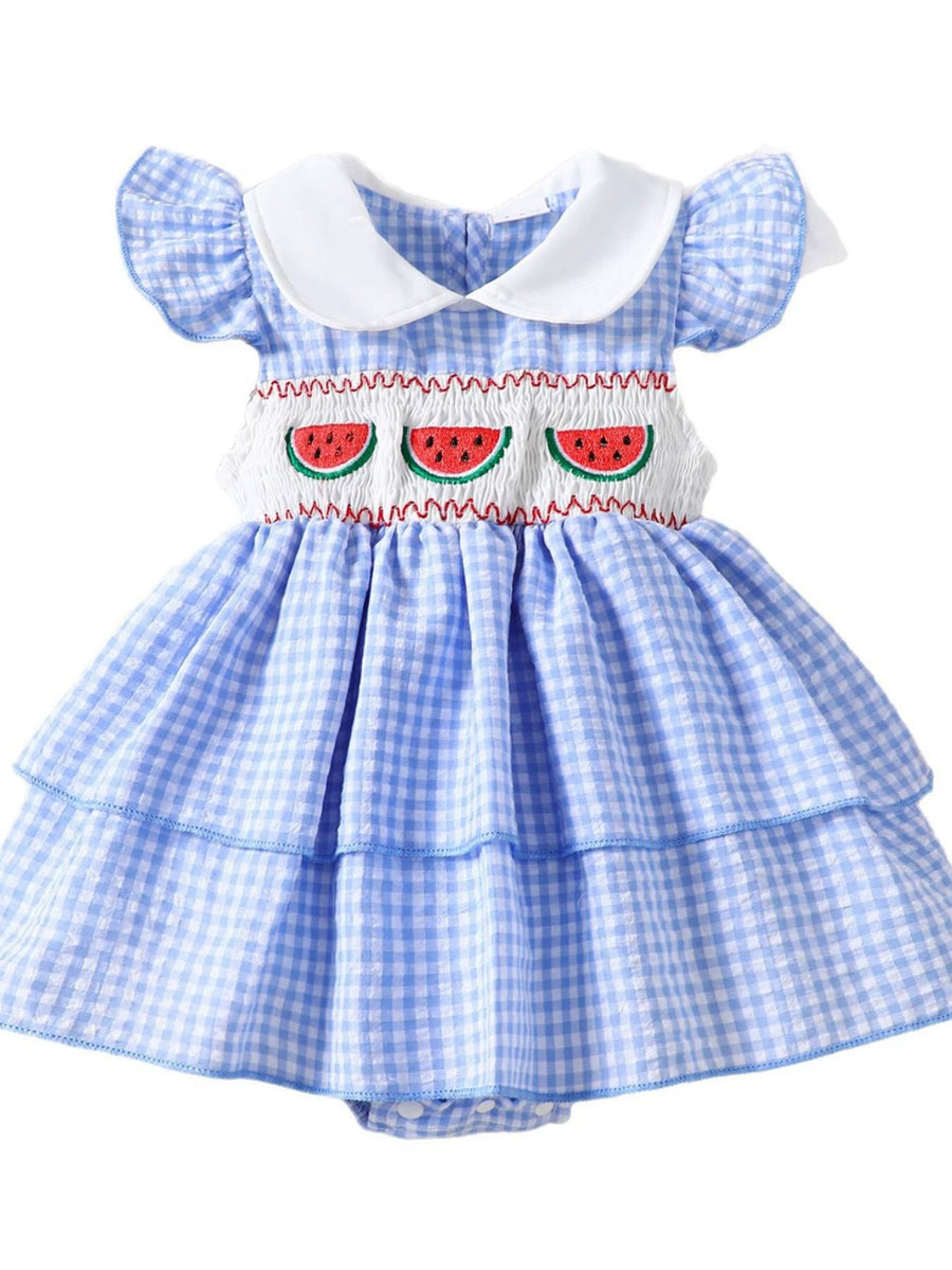 Baby dress in pastel blue gingham with fruit embroidery and ruffled sleeves.
