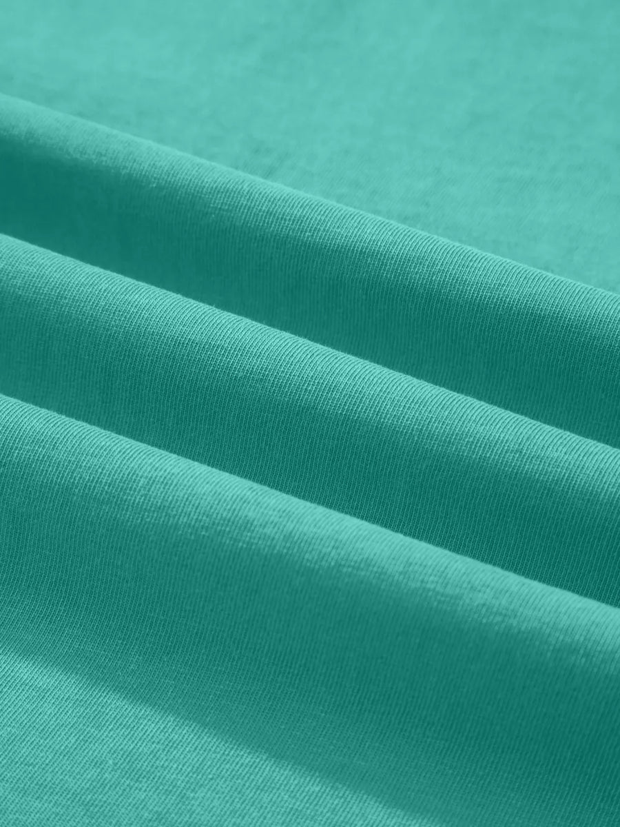 Teal mineral wash cotton tee with soft texture and subtle ribbing detail.